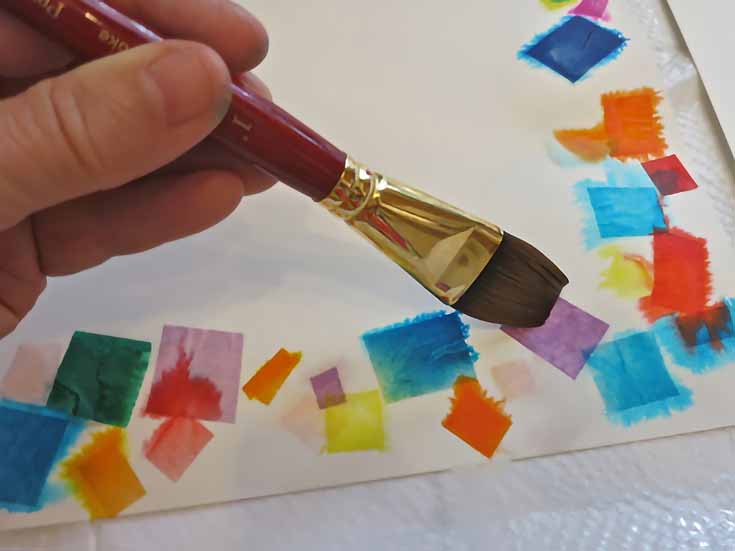 Wet the tissue paper with water so the color spreads to the paper