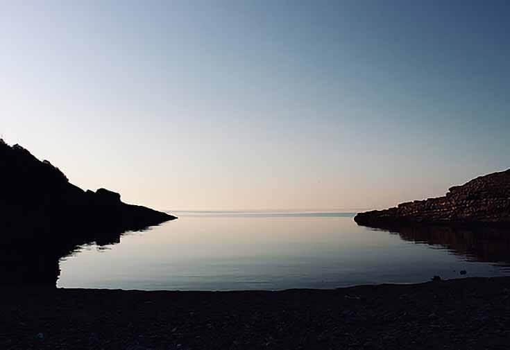 Photo of a serene beachfront cover at dusk