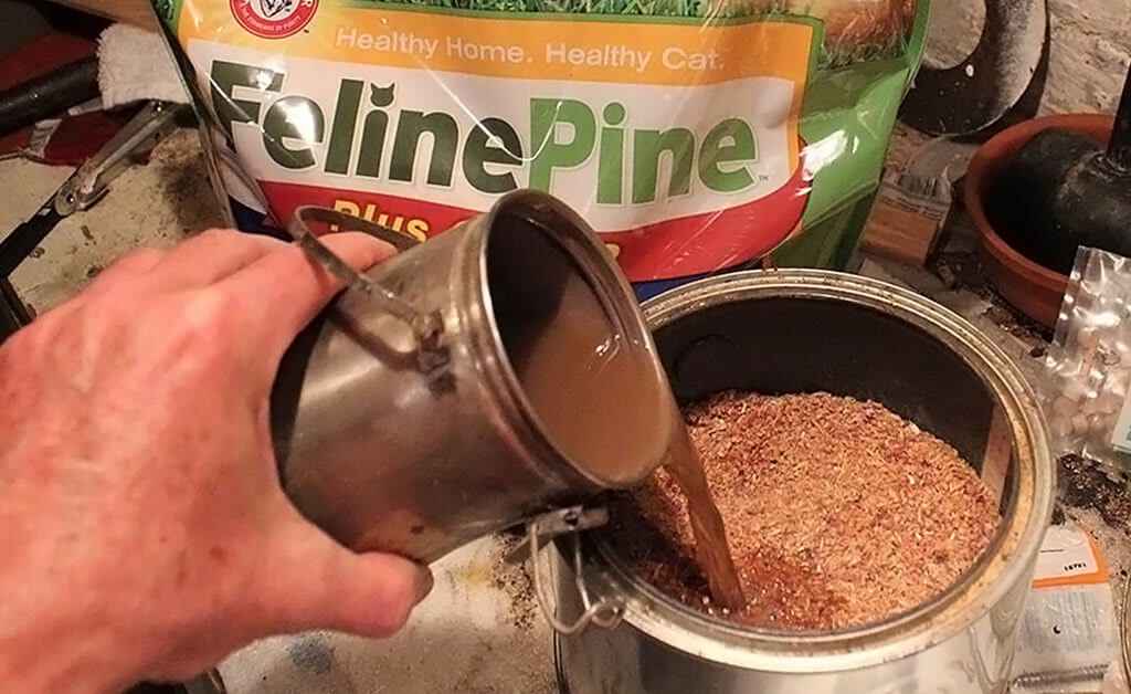 Photo showing used turpentine being poured into sawdust for recycling