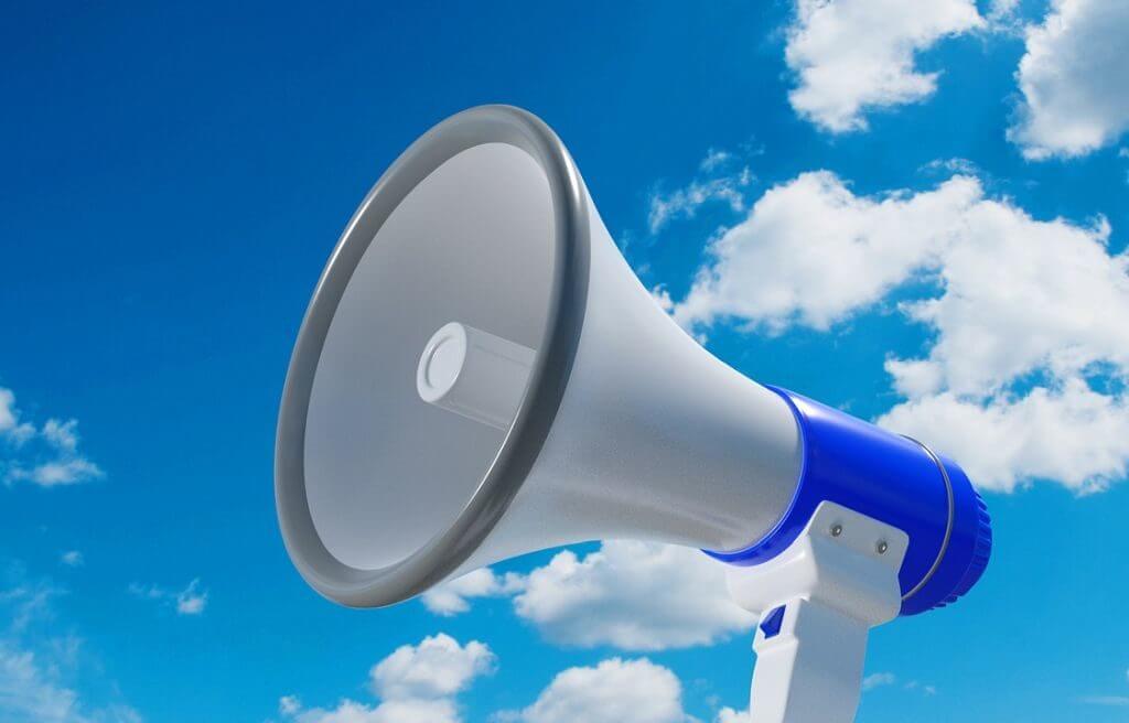 A megaphone held up against the sky